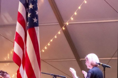 Marcia Bornhurst Parkes, Music Director, Leading the Melody Masters Big Band and the audience in the National Anthem, Big Tent venue, Rochester International Jazz Festival, June 25, 2022. Photo by Marcie Ver Ploeg for Rochester International Jazz Festival